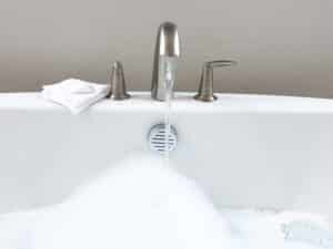 Elegant,White,Bathtub,Filled,With,Water,,Featuring,A,Sleek,Brushed