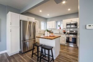 two-black-wooden-bar-stools-near-table-and-french-door-1663263-1-1024×683