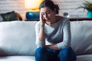 worried-young-woman-thinking-while-sitting-on-sofa-EWPZYAY-min-scaled-1-1024×683